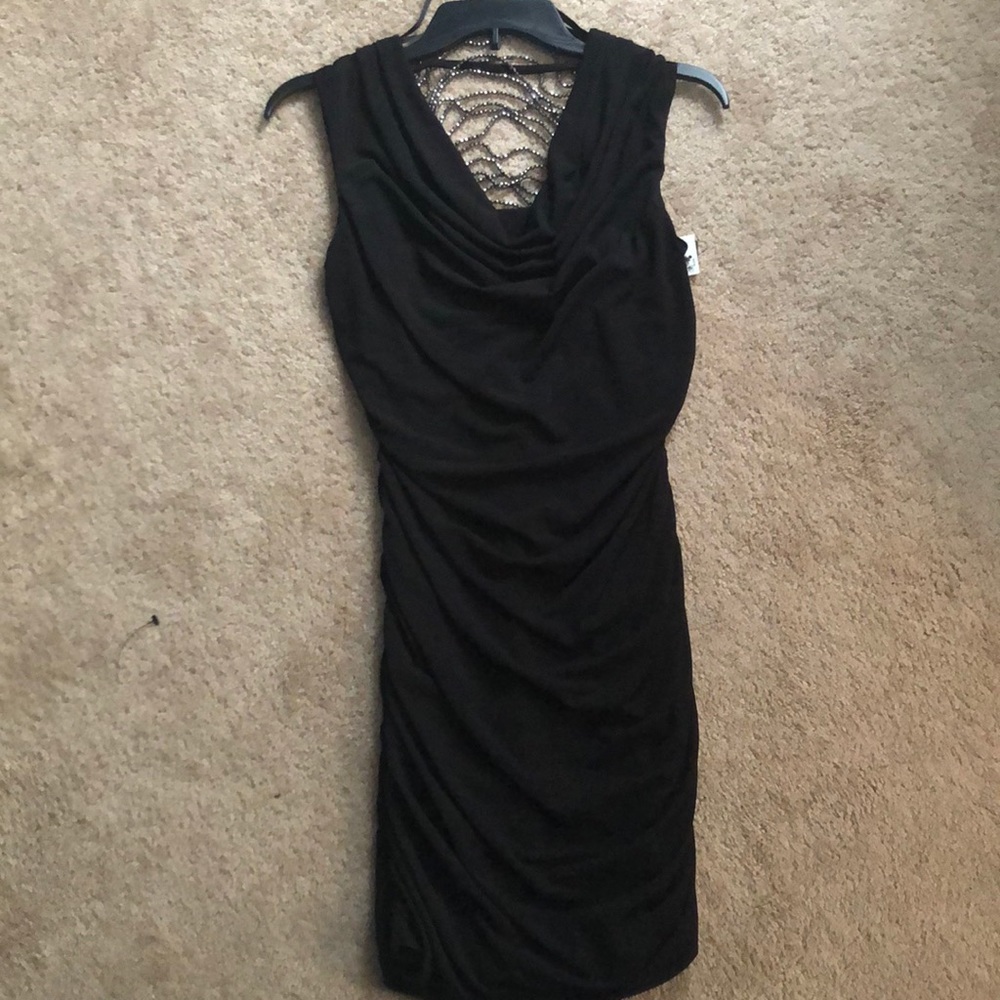 Tight black dress with crystals on open back